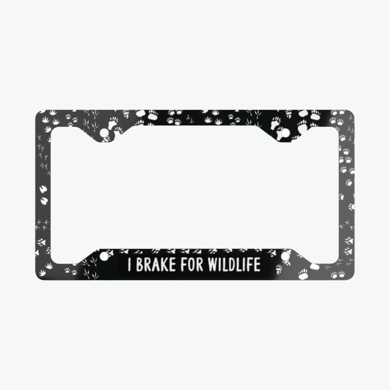 I Brake for Wildlife license plate frame with white animal paw prints on black metal frame for wildlife lovers and eco conscious drivers