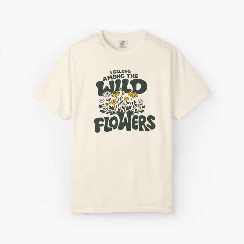 Among the Wildflowers unisex tee featuring retro lettering with hand drawn floral design in earthy tones for cottagecore aesthetic