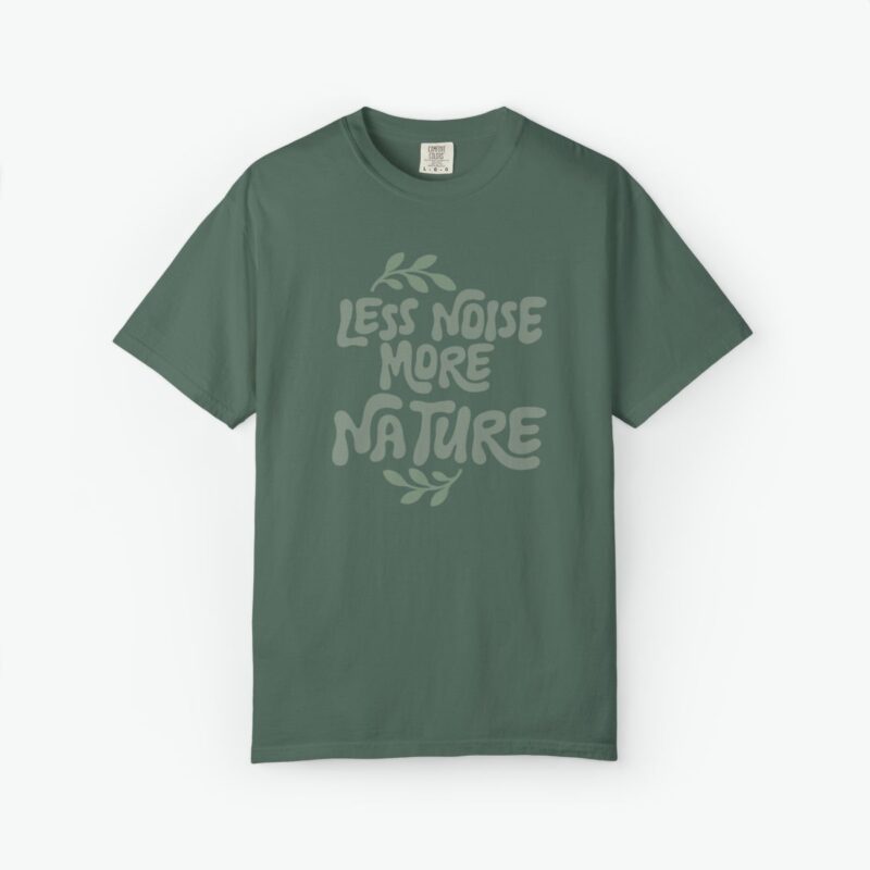 less noise more nature t-shirt featuring soft green typography with leaf accents on a garment-dyed unisex tee